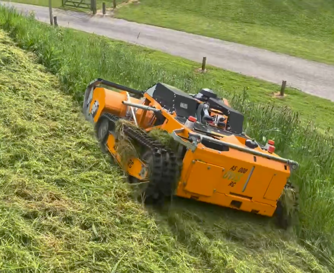 Commercial robot mower tackling a steep grass bank